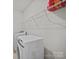 Bright laundry room with modern washer and dryer, plus storage shelving at 9582 Creighton Nw Rd, Concord, NC 28027