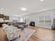 Inviting living room featuring a cozy fireplace, plush seating, and an open floor plan at 9582 Creighton Nw Rd, Concord, NC 28027