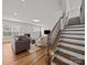 Elegant staircase with dark iron railings and hardwood steps leading to the upper level at 9582 Creighton Nw Rd, Concord, NC 28027