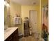 Bright bathroom featuring a dark vanity, mirrored cabinet, decorative towels, and tropical-themed shower curtain at 9608 Brackenview Ct, Charlotte, NC 28214
