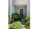 Charming front entrance with beautiful landscaping and a welcoming brown door at 9608 Brackenview Ct, Charlotte, NC 28214