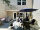 View of a patio featuring patio furniture, a blue umbrella, and an exterior door with sidelight at 9608 Brackenview Ct, Charlotte, NC 28214