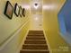 Carpeted staircase leading to the upper level with bright yellow walls at 9608 Brackenview Ct, Charlotte, NC 28214