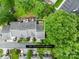 Aerial view of townhome roof with mature trees, landscaping, and parking areas at 9639 Green Gable Ct, Charlotte, NC 28270