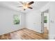Clean bedroom with ceiling fan, wood-look floors, and lots of natural light at 9639 Green Gable Ct, Charlotte, NC 28270