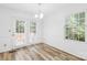 Bright dining area with wood-look flooring, and doors to the backyard at 9639 Green Gable Ct, Charlotte, NC 28270