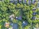 Expansive aerial view of a neighborhood with mature trees and a large grassy lot surrounded by homes at 11407 Lenswood Ct, Charlotte, NC 28214