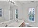 Well lit bathroom features a double sink vanity and a window at 11407 Lenswood Ct, Charlotte, NC 28214