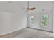 Bright bedroom features plush carpeting, two windows, and a ceiling fan at 11407 Lenswood Ct, Charlotte, NC 28214