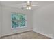 Bright bedroom with plush carpeting and a large window at 11407 Lenswood Ct, Charlotte, NC 28214