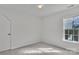 Bedroom featuring neutral carpeting, large window and overhead lighting at 11407 Lenswood Ct, Charlotte, NC 28214