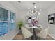 Bright dining room featuring stylish light fixture, modern art, and ample natural light from a large window at 11407 Lenswood Ct, Charlotte, NC 28214