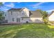 Back exterior featuring lush green grass, deck, and vinyl siding at 11407 Lenswood Ct, Charlotte, NC 28214