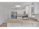 Bright kitchen featuring stainless steel appliances, white cabinets, light countertops, and wood-look floors at 11407 Lenswood Ct, Charlotte, NC 28214
