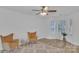 Bright living room featuring two yellow armchairs, a white wall, neutral rug, and wood-look floors at 11407 Lenswood Ct, Charlotte, NC 28214