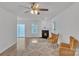Bright living room featuring a fireplace, two yellow armchairs, and a sliding glass door at 11407 Lenswood Ct, Charlotte, NC 28214