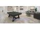 This staged basement features a billiards area and a comfortable living space, perfect for relaxation and entertainment at 1224 E Woodlawn Rd, Charlotte, NC 28209