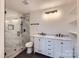 Bathroom featuring a glass shower, white vanity with dual sinks, and modern fixtures at 1224 E Woodlawn Rd, Charlotte, NC 28209