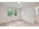 Bright bedroom featuring a window and hardwood floors at 1224 E Woodlawn Rd, Charlotte, NC 28209