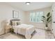 Bedroom with a bed, carpet, and large window for ample natural light at 1224 E Woodlawn Rd, Charlotte, NC 28209