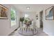 Staged dining area with round table, natural light, and neutral decor at 1224 E Woodlawn Rd, Charlotte, NC 28209