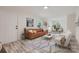Bright, staged living room with modern furniture, light wood flooring, and ample natural light at 1224 E Woodlawn Rd, Charlotte, NC 28209