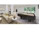 Relaxing living room featuring a large sectional sofa, pool table, and bright windows at 1224 E Woodlawn Rd, Charlotte, NC 28209