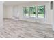 This is a well-lit living room featuring large windows that offer an expansive view of the outdoors at 1224 E Woodlawn Rd, Charlotte, NC 28209