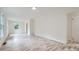 Spacious room with hardwood floors, white walls, and ample natural light at 1224 E Woodlawn Rd, Charlotte, NC 28209