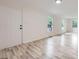 Bright living room with hardwood floors, white walls, and large windows at 1224 E Woodlawn Rd, Charlotte, NC 28209