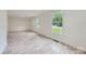 Large room featuring hardwood floors, white walls, and an abundance of natural light at 1224 E Woodlawn Rd, Charlotte, NC 28209