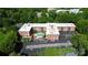 Aerial view of a brick condo complex with a central courtyard pool, surface parking, and tree lined perimeter at 1300 Queens Rd # 409, Charlotte, NC 28207