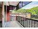 Spacious balcony with railing and outdoor view of the surrounding trees and neighborhood at 1300 Queens Rd # 409, Charlotte, NC 28207