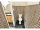 Half-bath showcasing wood slat-look tile, black hexagon floor tile, and modern commode at 1300 Queens Rd # 409, Charlotte, NC 28207