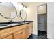 Bathroom featuring double sinks, black countertop, and unique tiled shower at 1300 Queens Rd # 409, Charlotte, NC 28207