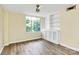 Bedroom featuring a built-in hutch, ceiling fan, and hardwood floors at 1300 Queens Rd # 409, Charlotte, NC 28207