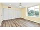 Bright bedroom with wood-look floors, fan, and natural light at 1300 Queens Rd # 409, Charlotte, NC 28207