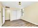 Bedroom with closet, bright window, hardwood floors, and ensuite access at 1300 Queens Rd # 409, Charlotte, NC 28207