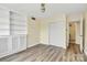 Bedroom with hardwood floors, built-ins, sliding door closet, and ceiling fan at 1300 Queens Rd # 409, Charlotte, NC 28207