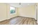 Bright bedroom with wood-look floors, large window, and natural light at 1300 Queens Rd # 409, Charlotte, NC 28207