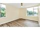 Bright bedroom featuring wood-look flooring, neutral walls and multiple windows at 1300 Queens Rd # 409, Charlotte, NC 28207