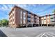 Exterior elevation of the multi-story brick apartment building with covered parking at 1300 Queens Rd # 409, Charlotte, NC 28207