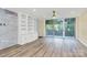Light-filled living room showcasing balcony access, built-in shelves, and wood flooring at 1300 Queens Rd # 409, Charlotte, NC 28207