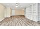 Open living space with hardwood floors, built-in shelving, and a ceiling fan at 1300 Queens Rd # 409, Charlotte, NC 28207
