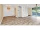 Spacious living area with hardwood floors, built-in shelving, and access to the balcony at 1300 Queens Rd # 409, Charlotte, NC 28207