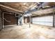 A spacious unfinished basement featuring concrete floor and a garage door at 1309 Poplar Cir, Newton, NC 28658