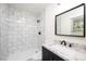 Bathroom featuring a black framed mirror and marble tiled shower enclosure at 1309 Poplar Cir, Newton, NC 28658