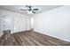 Bedroom featuring hardwood floors, a ceiling fan and a closet with a tiled bathroom at 1309 Poplar Cir, Newton, NC 28658
