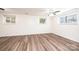 Bright bedroom featuring modern ceiling fan, three windows, and luxury vinyl plank flooring at 1309 Poplar Cir, Newton, NC 28658