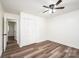 Bright bedroom featuring modern ceiling fan, spacious closet, and luxury vinyl plank flooring at 1309 Poplar Cir, Newton, NC 28658